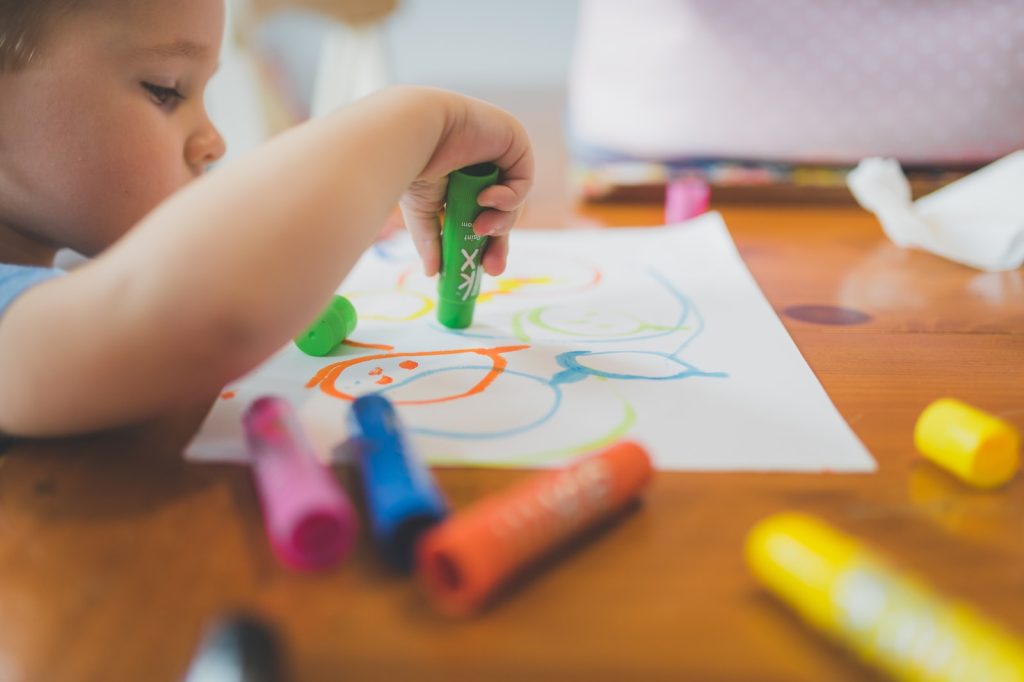 Young boy drawing on a piece of paper