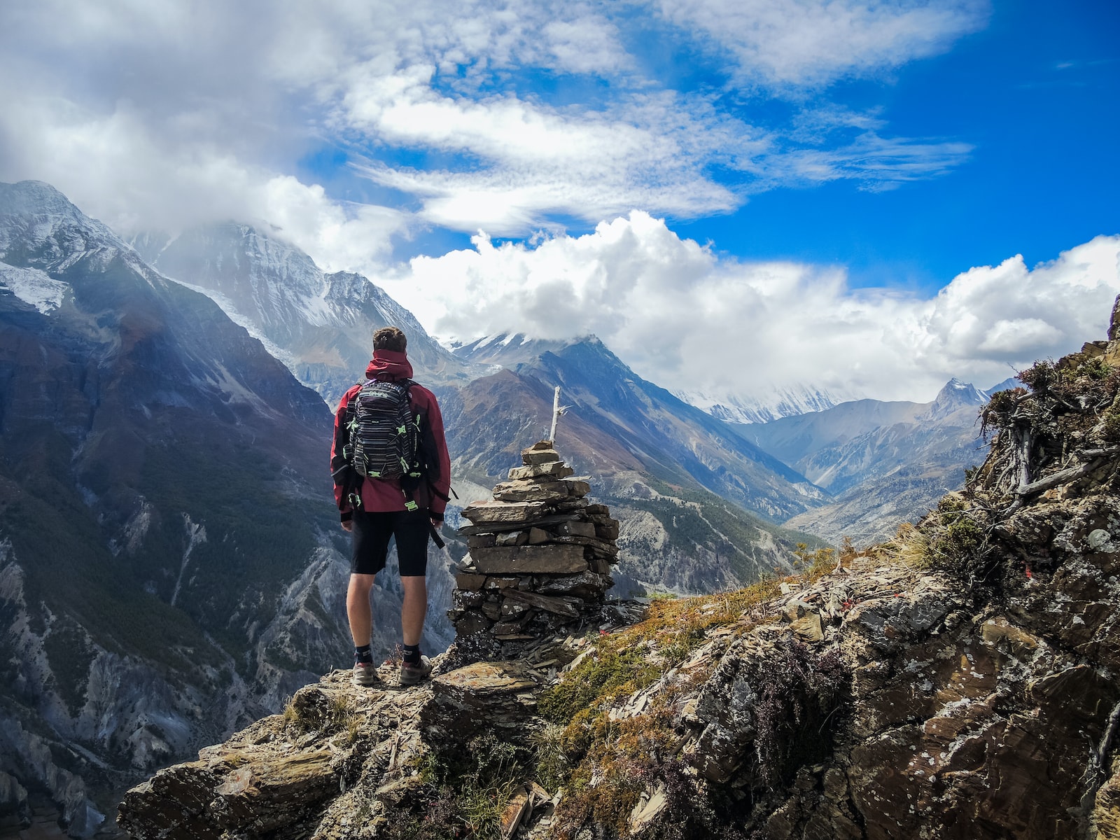 Guy standing on top of a mountain