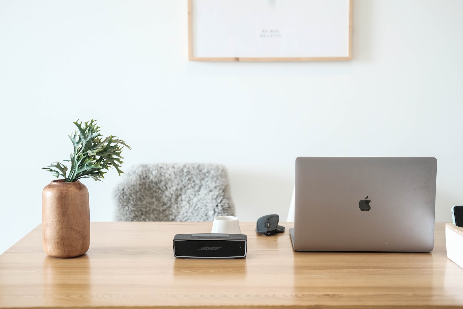 Laptop speaker and a vase on a table