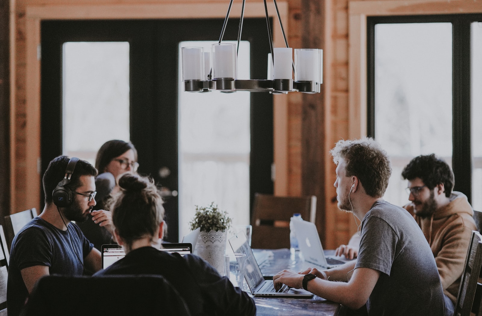 People sitting behind a table and working