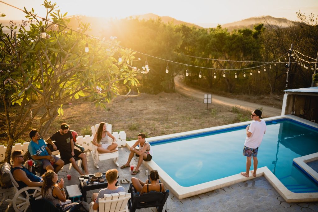 People sitting by a pool partying