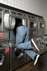 Person climbing into washing machine